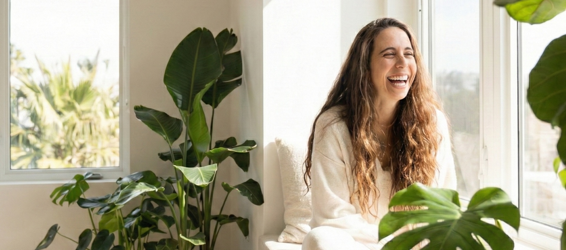 Maria House laughing surrounded by plants